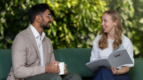 two people having a meeting on a green couch