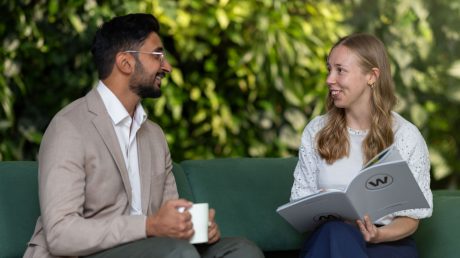 two people having a meeting on a green couch