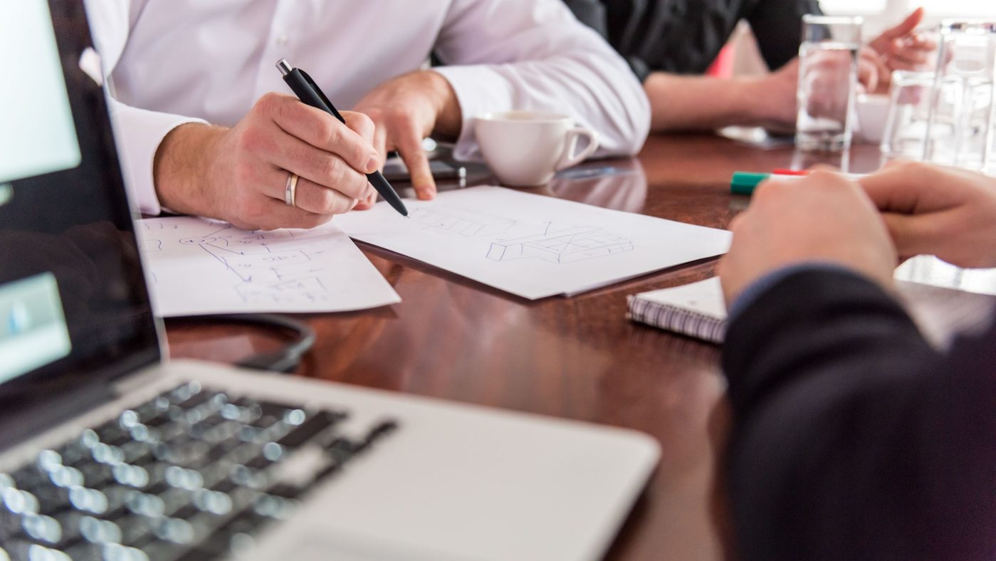 someone writing on notepad, meeting, office