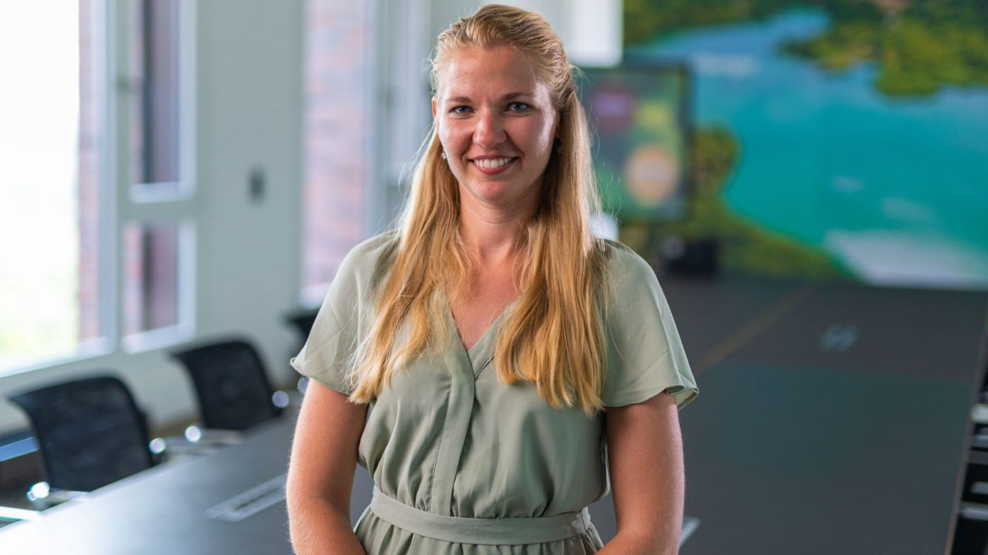 Woman talking to camera in a meeting room setting