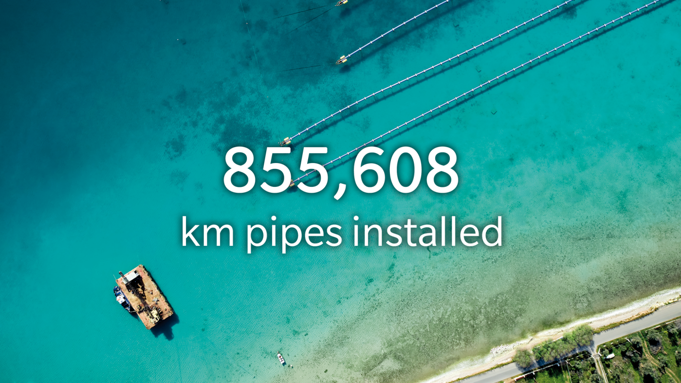 Long Length HDPE pipes in turquoise sea, ship, beach