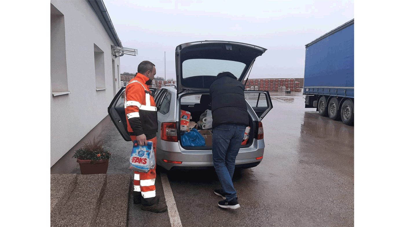 Two people load a trunk