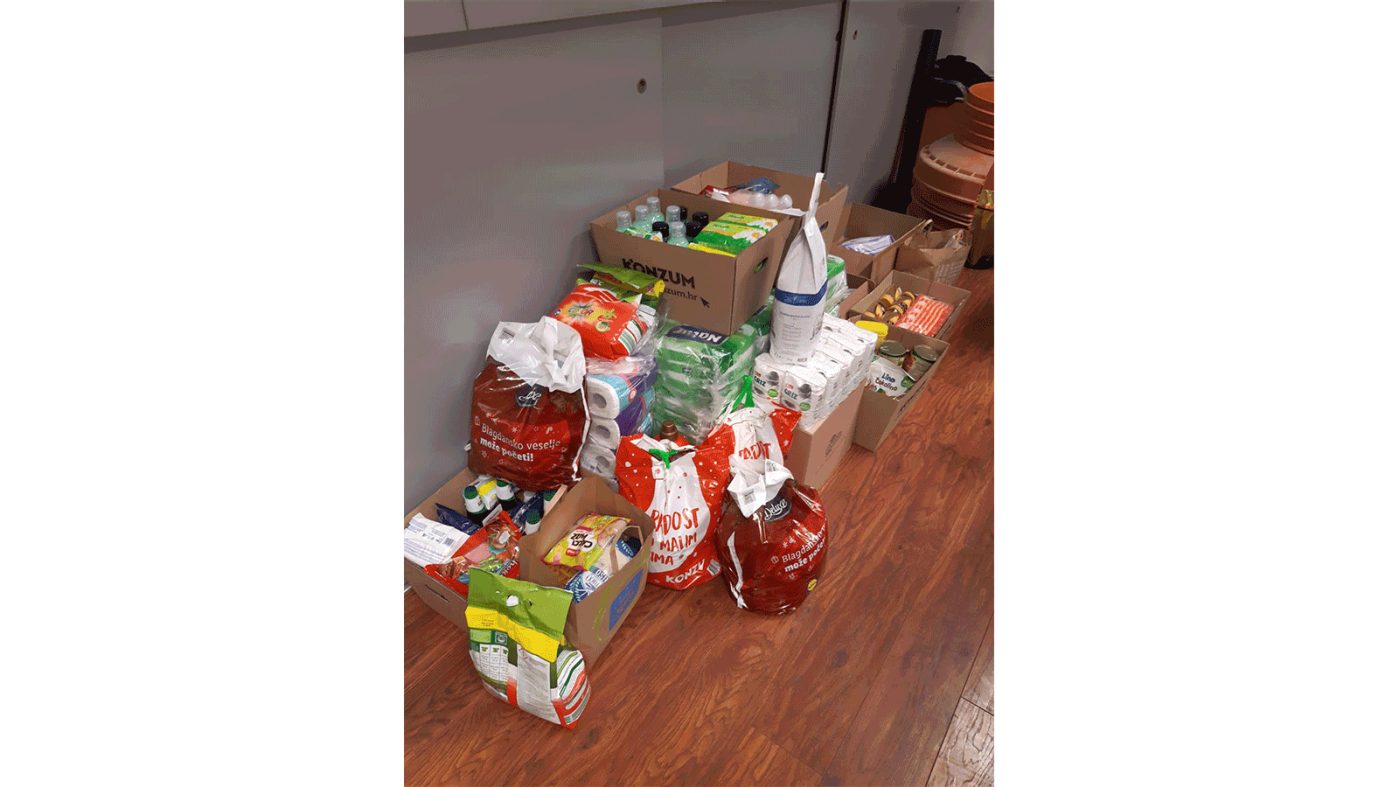Food and hygiene items in boxes and bags on the floor