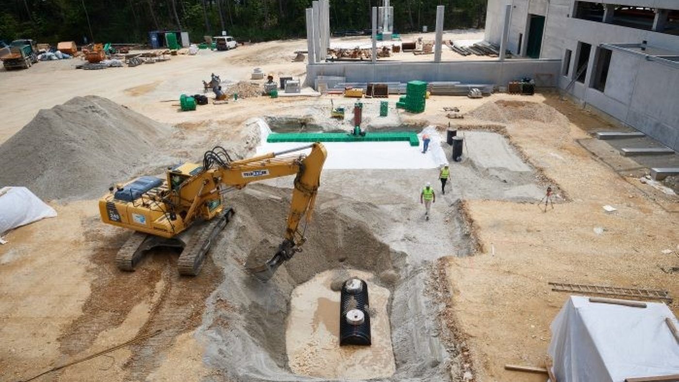 stormboxes beeing buried; excavator