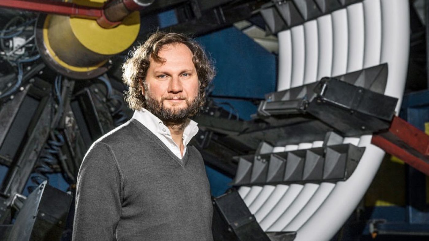 Man standing in front of a machine, pipes