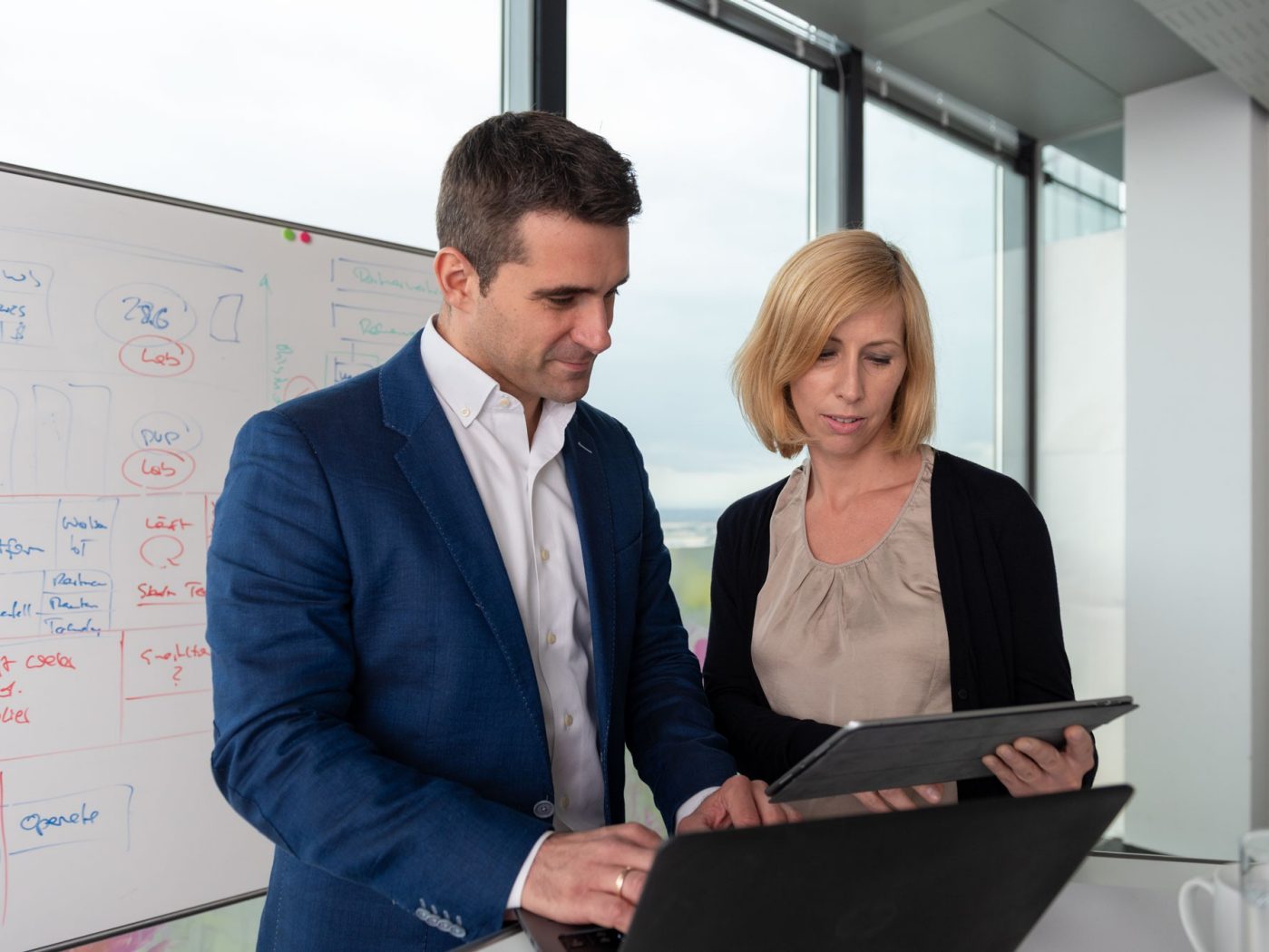 Male and female office worker with tablet computer