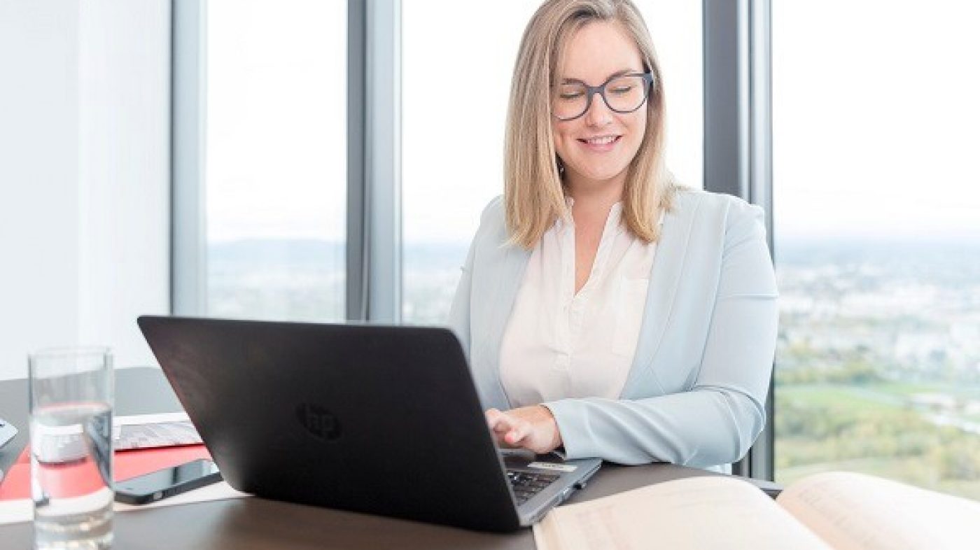 Woman with glases typing on laptop
