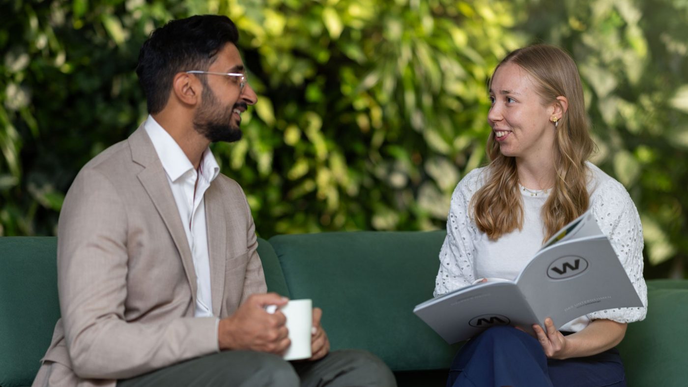 Two people talking on a sofa