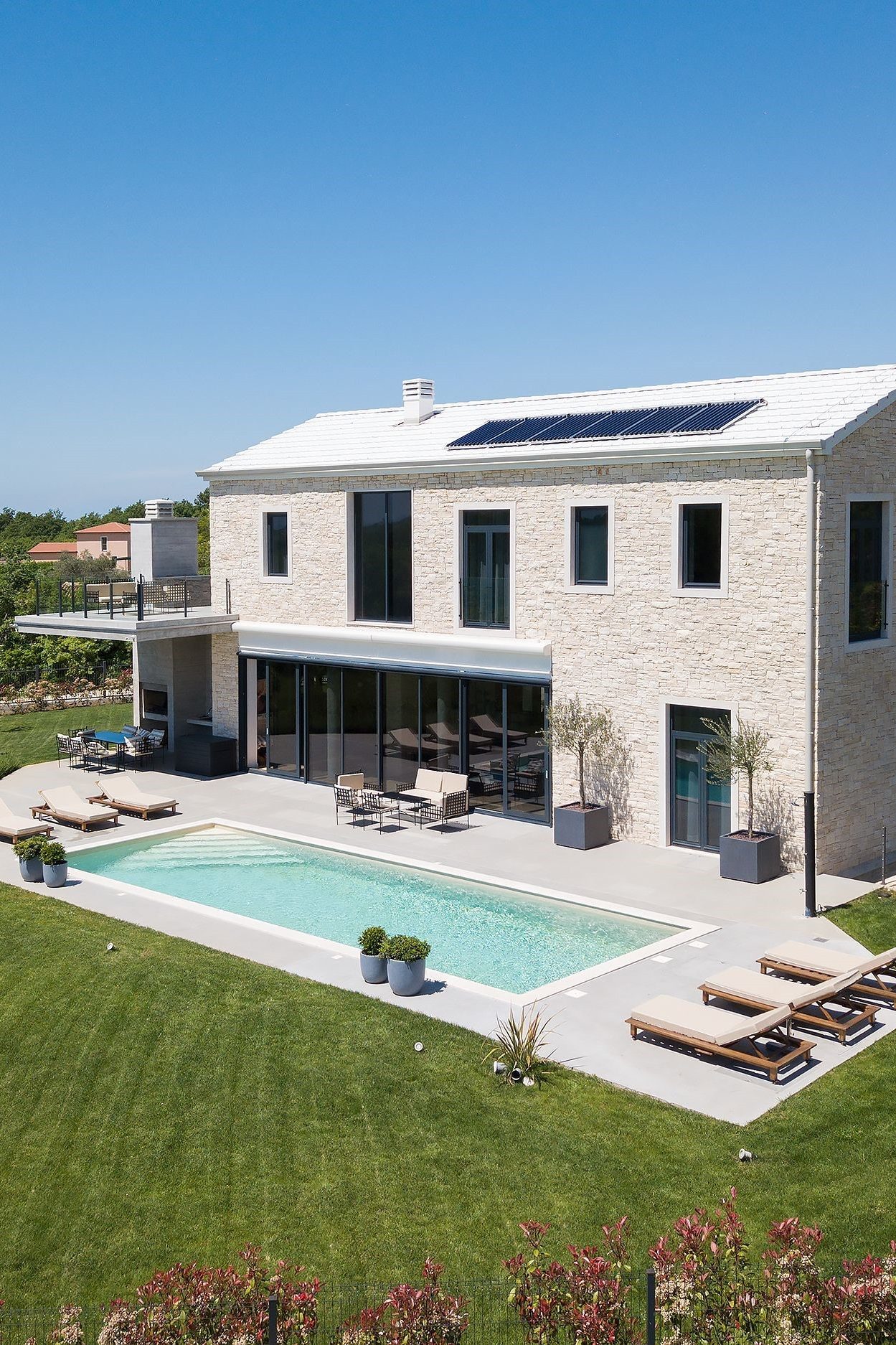 bright house with solar panels and pool