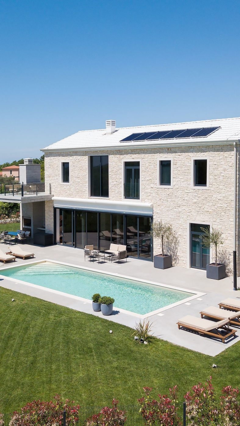 bright house with solar panels and pool