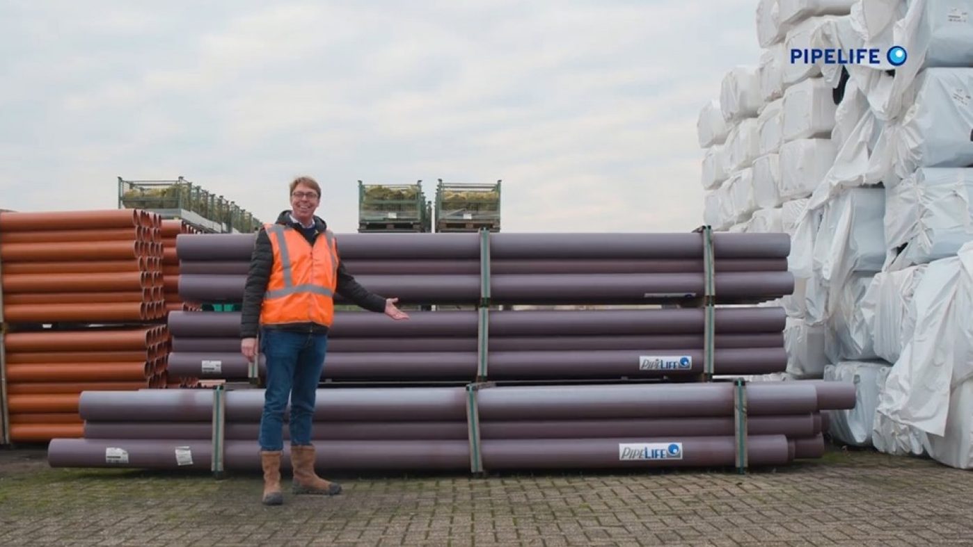 Man with orange jacket in front of Durofort stormwater pipes