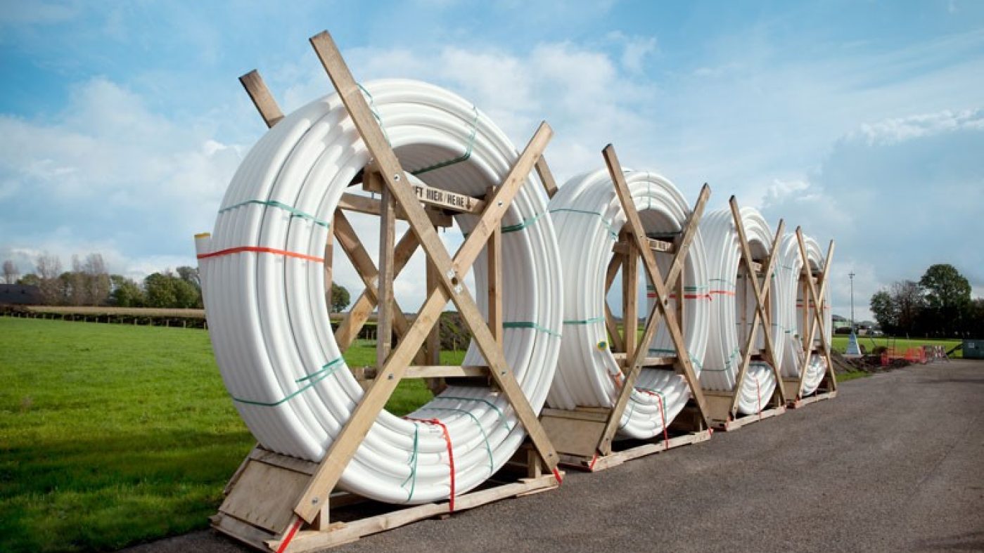 white pipes; green meadow, blue sky