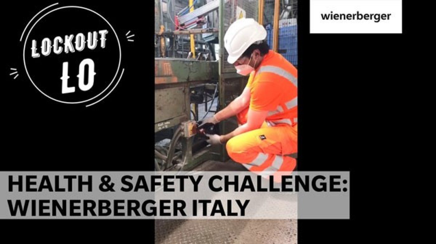 Man in safety clothing operates machine