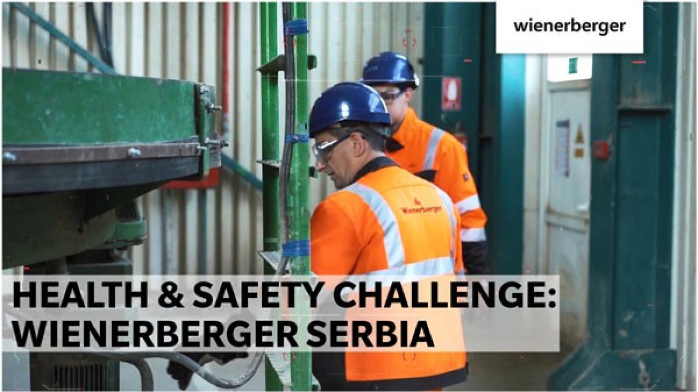 Two men are standing in front of a machine