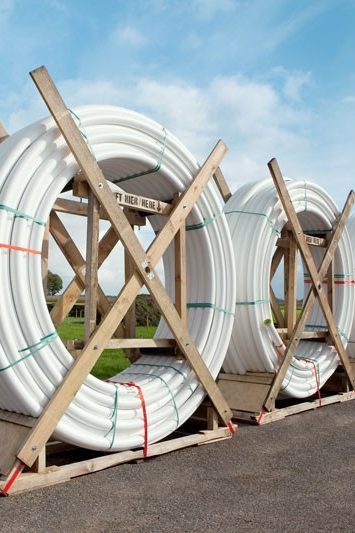 white pipes; green meadow, blue sky