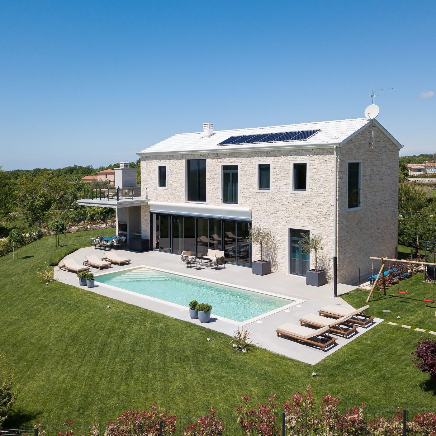 bright house with solar panels and pool