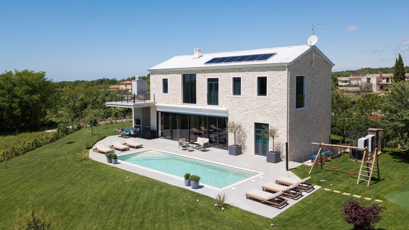 bright house with solar panels and pool