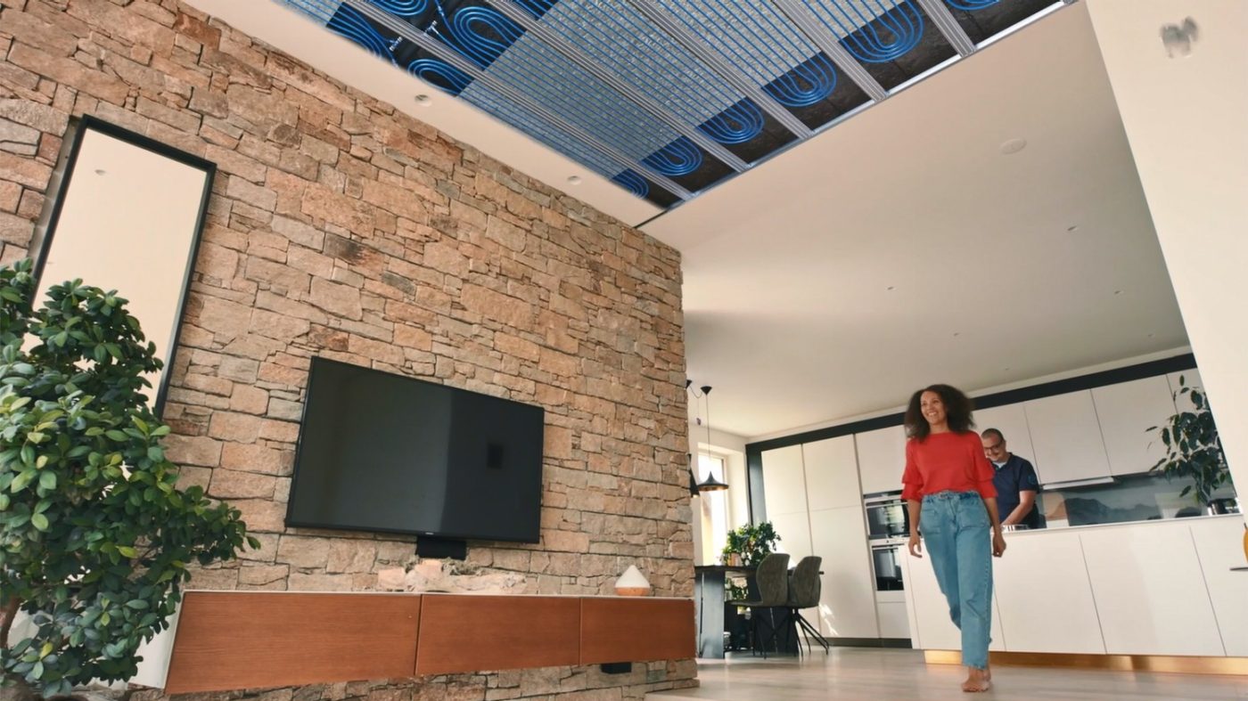 Woman walking through room, pipes for cooling in ceiling