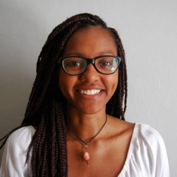 A woman with glasses smiling