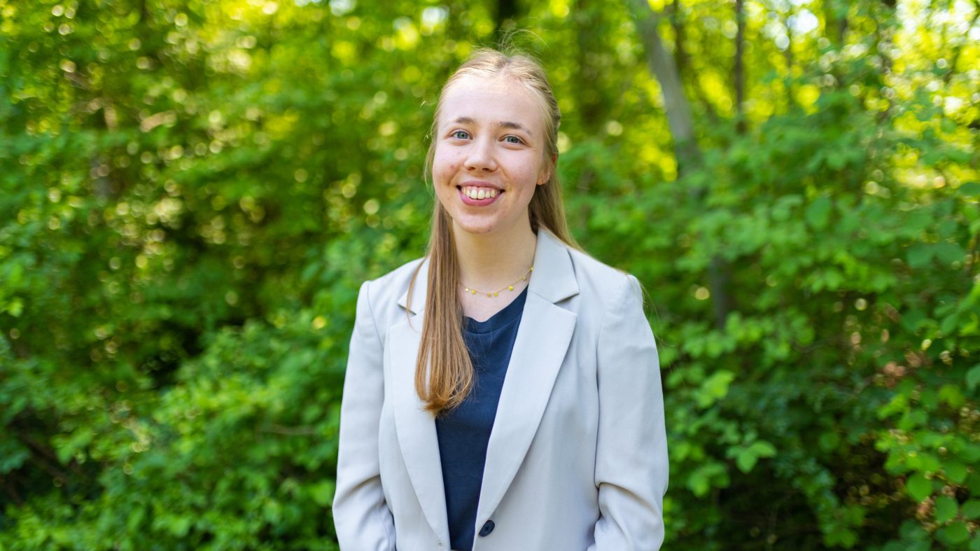 Woman smiling into camera, nature, forest, green