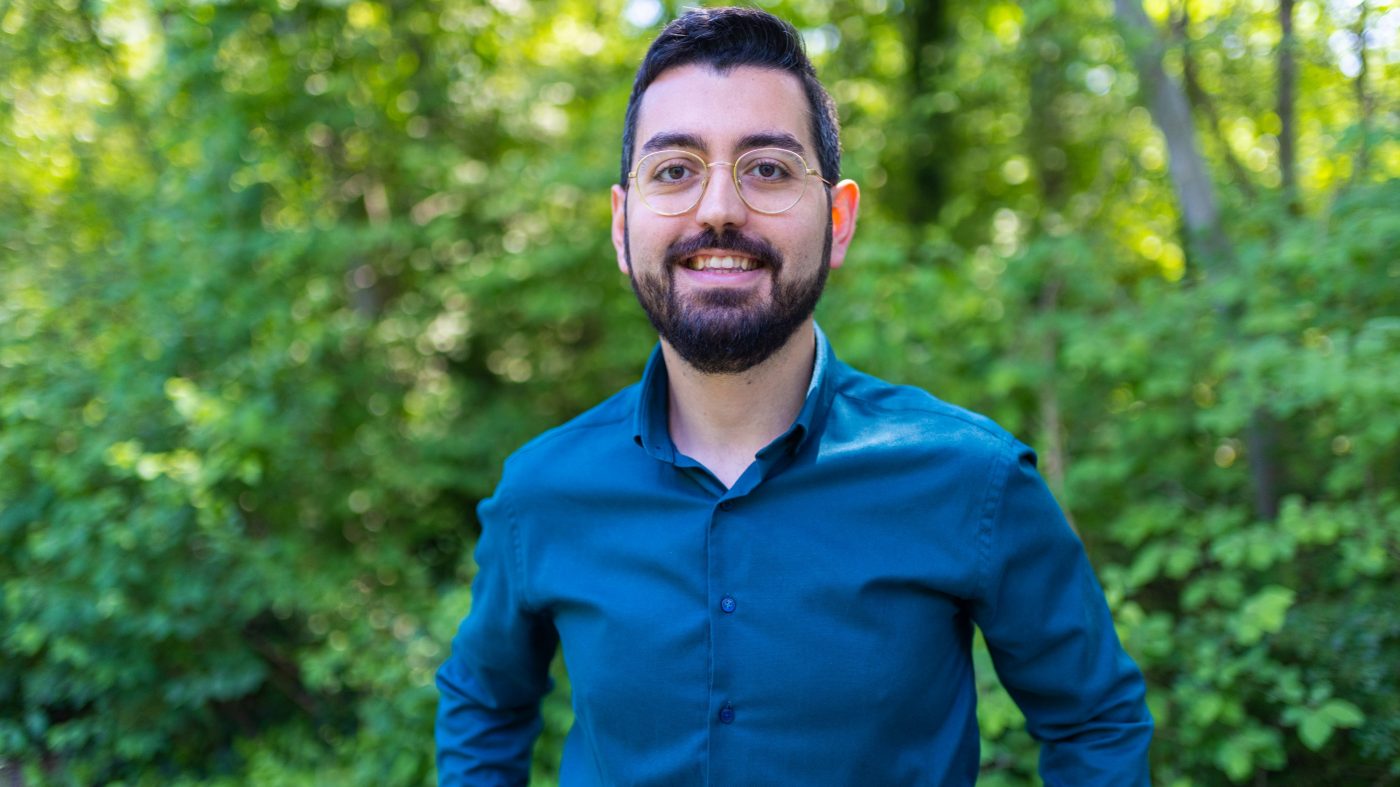 Man smiling into camera, nature, forest, green
