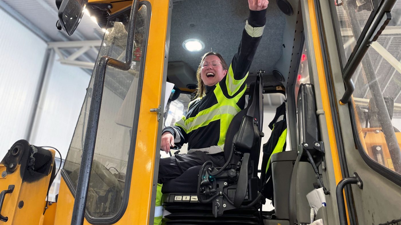female worker in a truck, happy