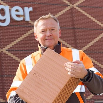 Johann Marchner with a Wiener Ton brick in front of the Wienerberger plant in Hennersdorf